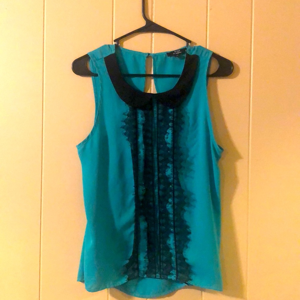 Retro, feminine blouse has delicate black lace detail. It’s incredibly flowy!